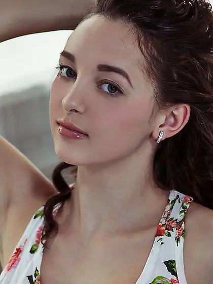 Denim shorts wavy-haired brunette slowly peeling off her clothes