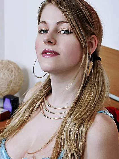 Smiling young woman with two ponytails removes blue bra and pant