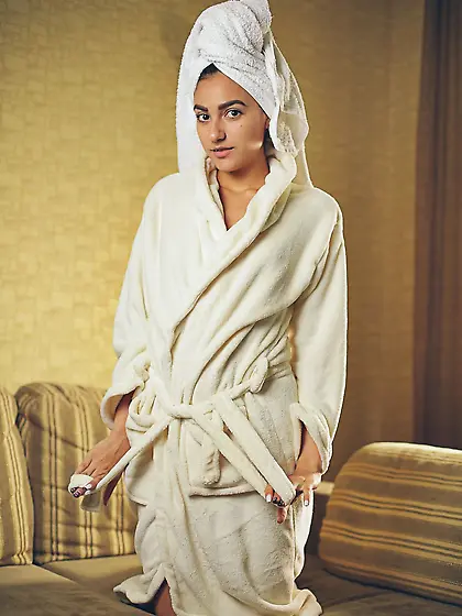 Whore with a towel on head and in white robe gives sexual pleasu