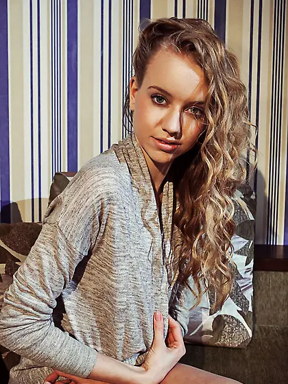 Young woman with small titties poses putting naked vagina in the