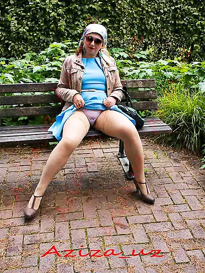 Muslim milf goes for a walk in the park and shows herself i