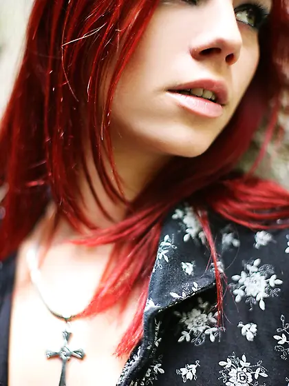 Misbehaving redhead shows her big breasts and looks astonishing