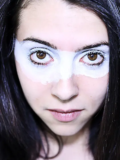 Painted eye masked brunette