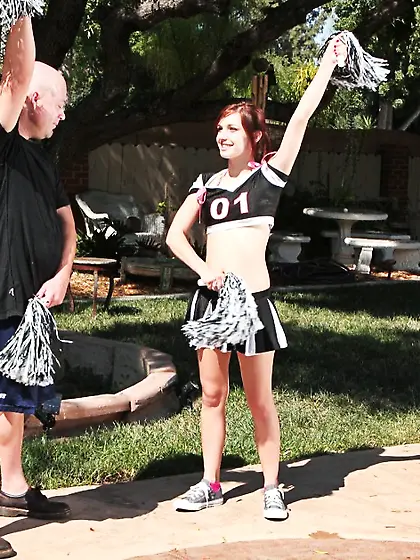 Freaky redhead cheerleader gets pleased by a older man outdoors.