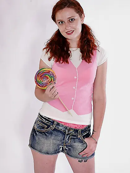 Dazzling redhead in knee socks can’t resist undressing and expos