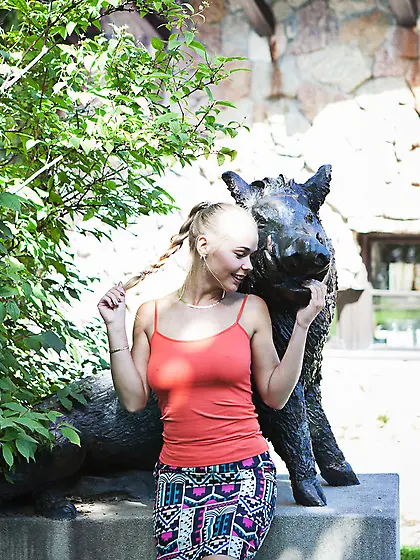 Tanned and busty blonde with braided hair strikes sexy poses on