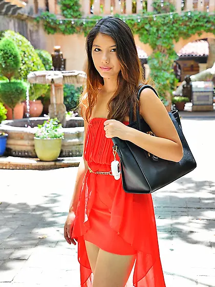 Young woman in a red dress discreetly exposes pussy during the w