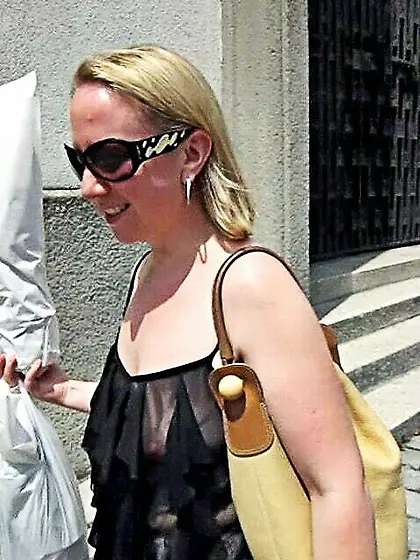In a frilly black top on the street