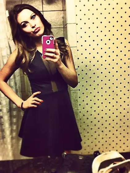 Blonde takes off her neon pink shirt to pose...