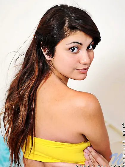 Alluring brunette gal Danni Dillion strips her pink panties and