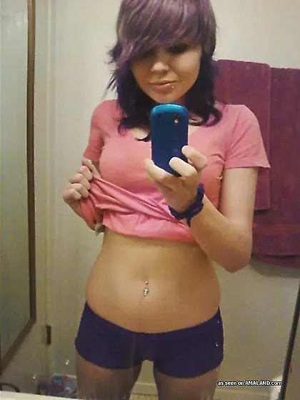 Purple hair rebellious emo teen showing her...