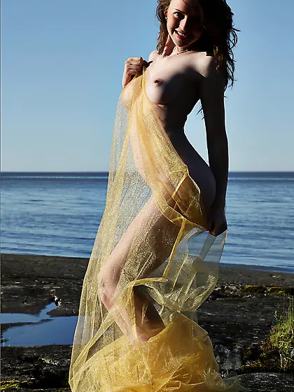 Alluring babe Nastya E uses her yellow veil to tease by the rive