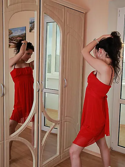 Frizzy-haired hottie in red lingerie showing off for the camera