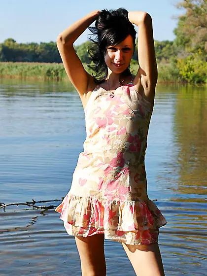 Dishy brunette teen Holly Nubiles in short dress goes in the riv