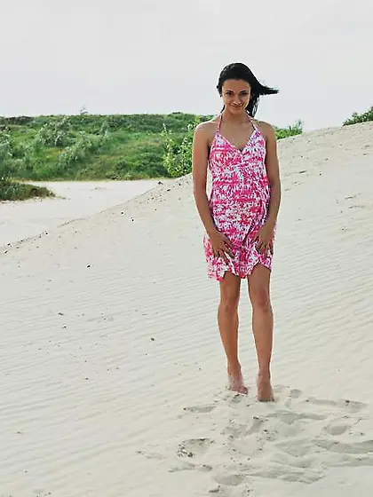 Brunette with long legs doing crazy splits while stripping on a