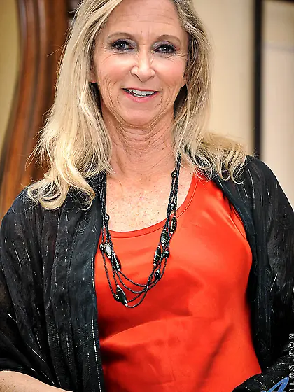 Provoking blonde mature Annabelle Brady bares her red garments a