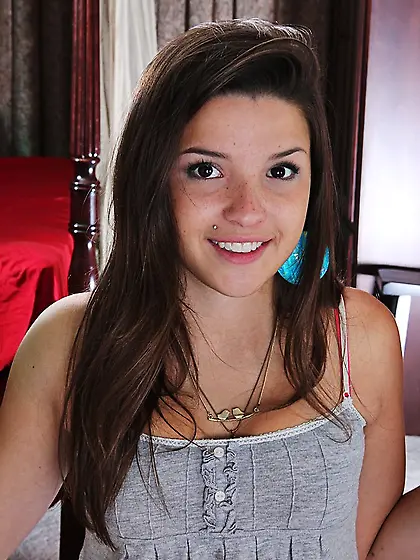 Smiling brunette teen Veronica Berry slips out of her clothes an