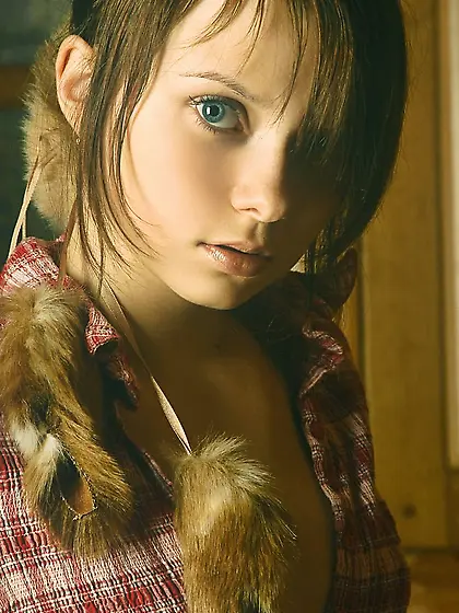 Young beauty with a flat belly posing in a cabin, looking really