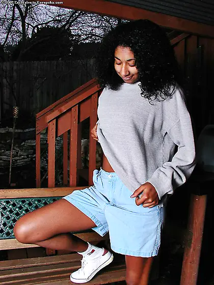 Dark skinned Penelope Lilac takes off her black panties and spre