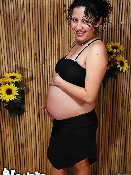 Beautiful pregnant woman undresses