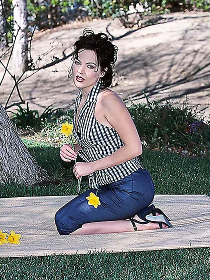 Claudia Atkins smells a flower.  She puts a vibrator in and rubs