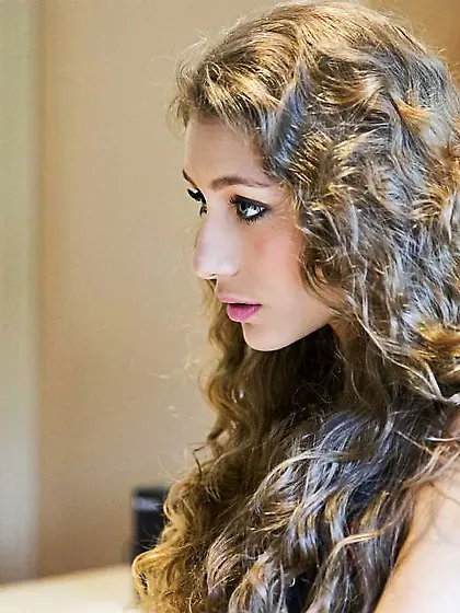 Curly haired teen rides cock with wild abandon 