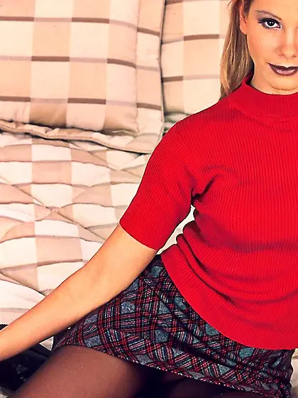 Classy blonde lady Sandy teases us on the bed in mini skirt and