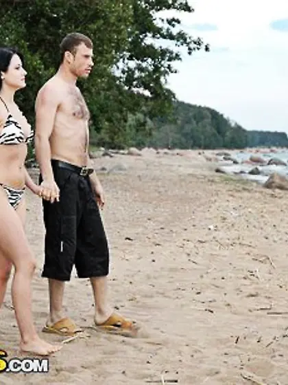 Girl with tempting bright eyes is nailed on the beach to facial