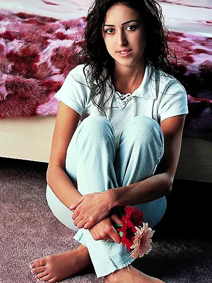 Sexy brunette Breanne Benson smells flowers and displays her ado