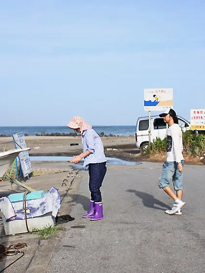 Japanese girl gets pleasured through her pants in rubber boots