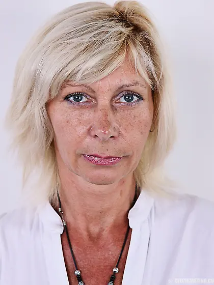 Mature blonde woman gets rid of white dress and lingerie remaini