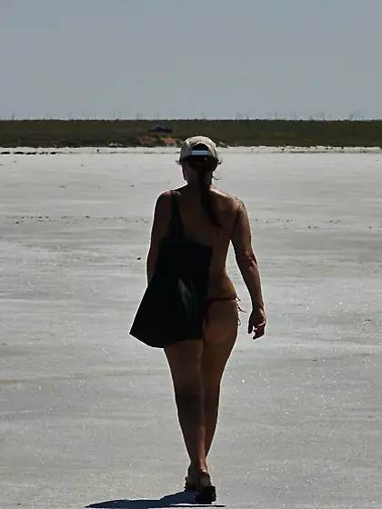 Standing naked on the salt of the salt lake Elton