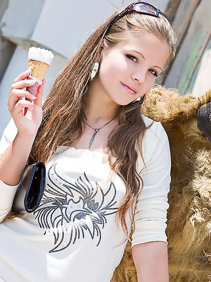 Brunette exploring a grassy filed with her pussy on full display