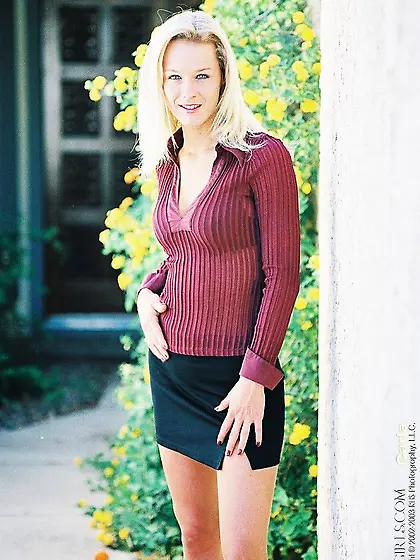 Sexy Blonde Carla knavishly looks into the cam when sitting with