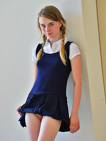 Pigtailed young blonde shows her butt-plugged ass and masturbate