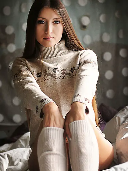 Slut in sweater and leg-warmers feels hot inside and gets naked