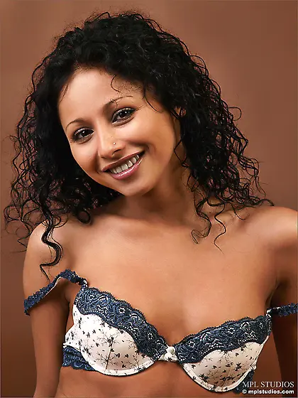 Curly young brunette chick Gloria A is sticking out her butt in