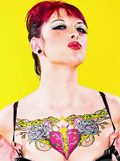 Sweetie with middle-sized boobs starts striptease on a yellow ba