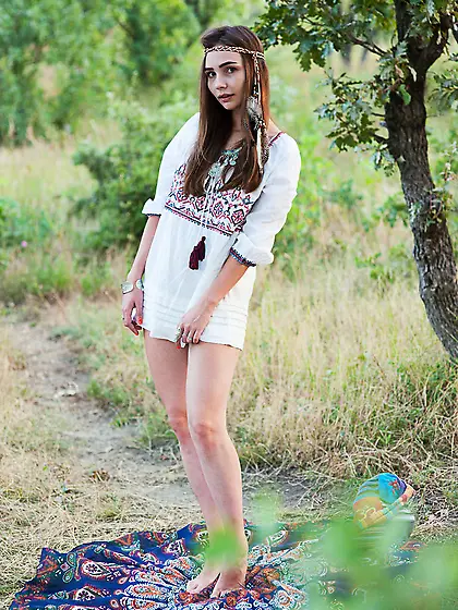 Sweet hippie girl feels unity with nature while relaxing nude in