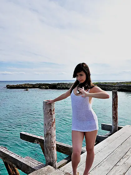 Yummy Ariel Rebel performs a fascinating action on a pier while