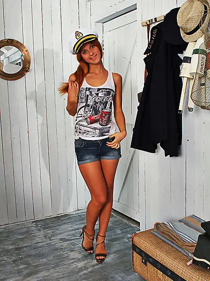 Skinny redhead adores marine theme and posing naked on the woode