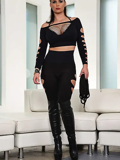 Attractive cougar in high boots erotically bends over to display