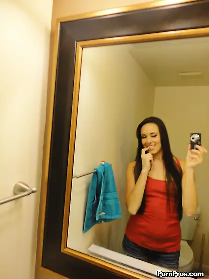 Slim brunette babe poses on camera in the narrow bathroom and la