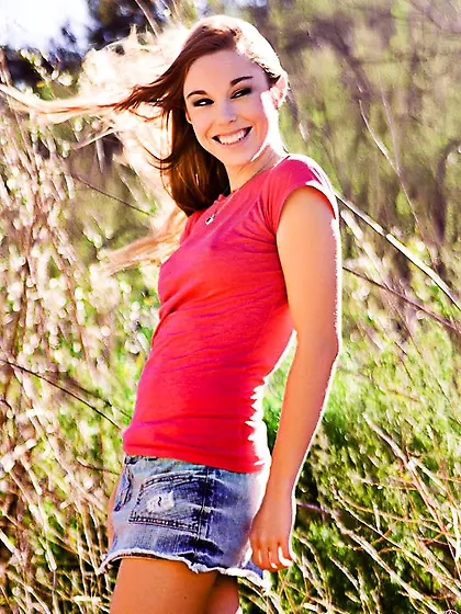 Lusty brunette Meghan Afterlife stripping and posing absolutely