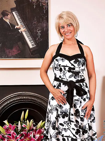 Lovely blonde MILF unhurriedly strips naked being in the mood to