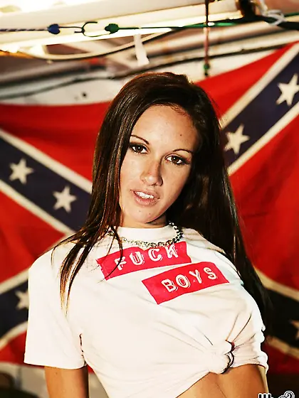 Seductive teen gal Taylor Rain strips in front of southern flag