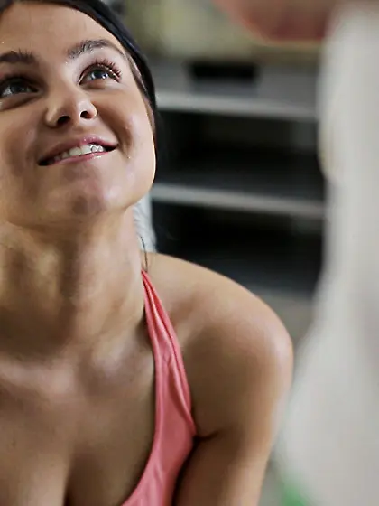 Pretty brunette sheds outfit