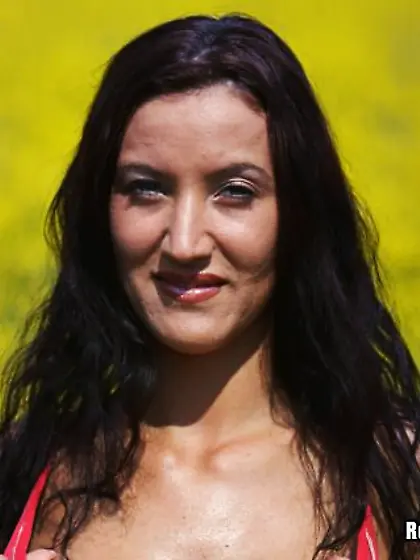 Long haired busty brunette Krisztina Ventura in red panties pose