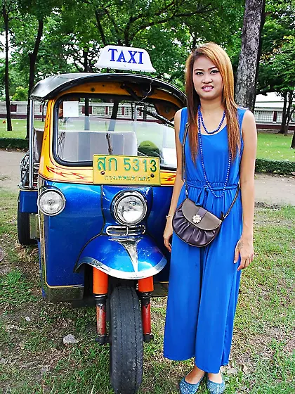 Hot female from Thailand poses in her slinky blue dress by a sma