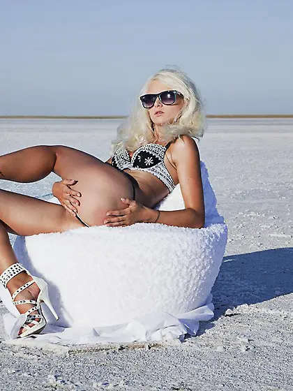 Tanned blonde with a gorgeous bod Nika N is getting nude outside